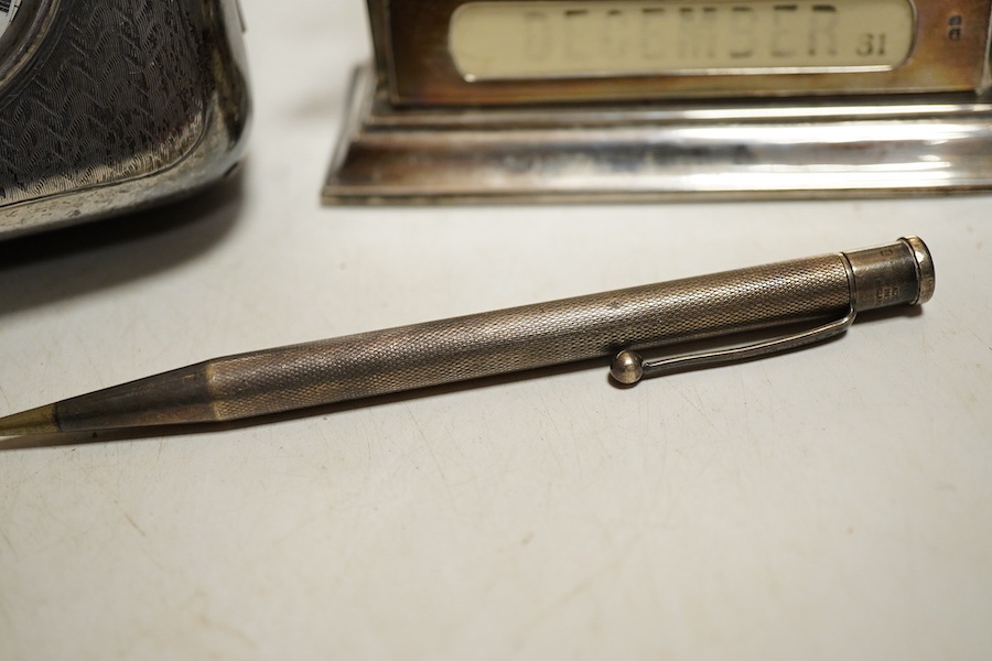 An Edwardian silver perpetual desk calendar, Birmingham, 1907, E F Braham, initalled, (mechanism a/f) together with an engine turned propelling pencil and a Swiss open faced poclet watch contained within a silver faced l